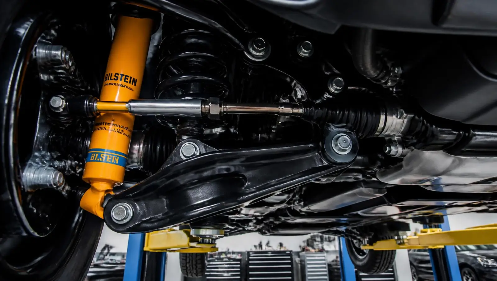 New suspension components being installed under a luxury SUV