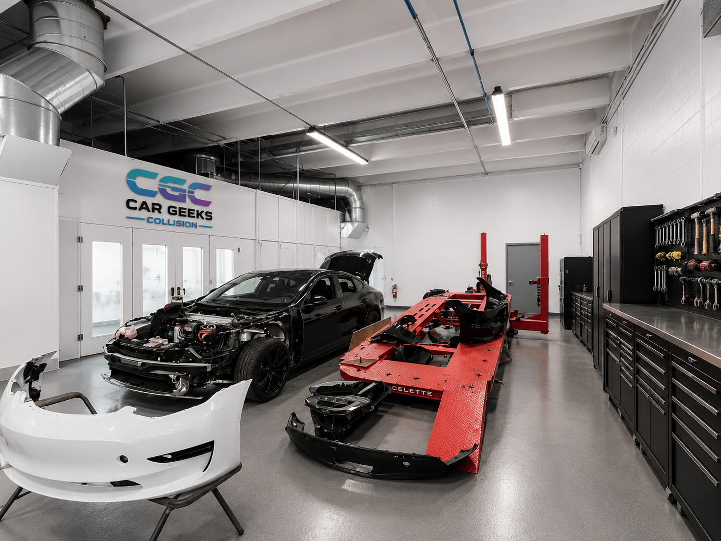Tesla Model 3 on Celette frame rack at Car Geeks Collision structural repair bay